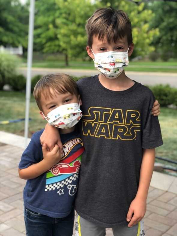 Boys ready to venture out with masks on
